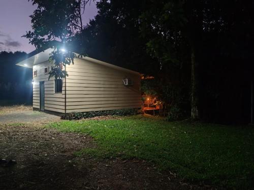 a building with a light on the side of it at night at Charmin forest cabin in Fortuna