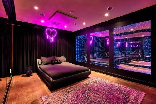 a bedroom with a bed and purple lighting at Beyond: Historic Rock & Roll Studio in Sunfair Heights