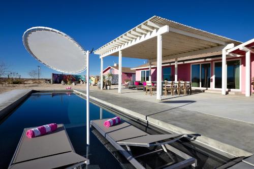 a pool with two chairs and a large mirror at Beyond: Historic Rock & Roll Studio in Sunfair Heights