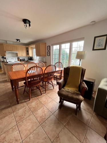 a kitchen and dining room with a table and chairs at Water front Golden Lake cottage - Calm and peaceful in Val-David
