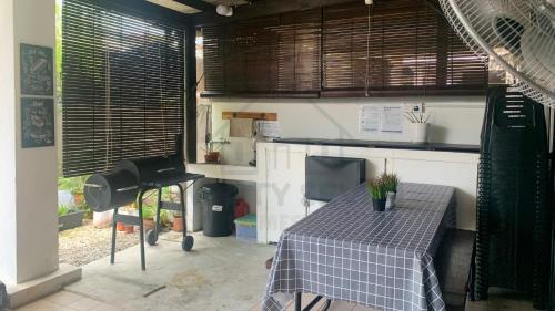 a kitchen with a table with a table cloth on it at 27Homestay - Landed House, Complete Facilities with 3Br & WiFi in Cheras