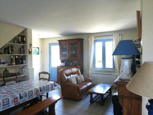a living room with a couch and a chair at Spacieuse maison familiale à Groix avec jardin - FR-1-813-21 in Groix