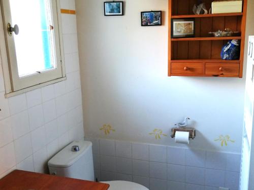 a bathroom with a toilet and a sink and a window at Spacieuse maison familiale à Groix avec jardin - FR-1-813-21 in Groix