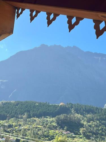 a view from a window of a mountain valley at Les 3 Chalets de Cilaos in Cilaos
