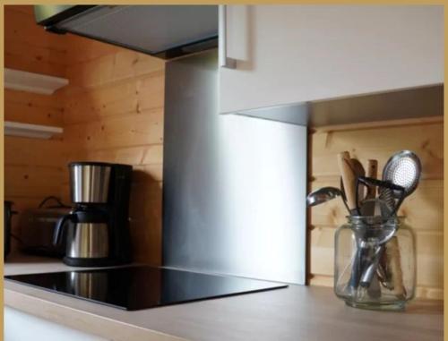 a kitchen with a counter top with utensils at Les 3 Chalets de Cilaos in Cilaos