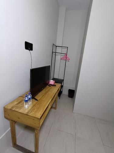 a room with a wooden table and a mirror at Jogja Amor Hotel in Demangan
