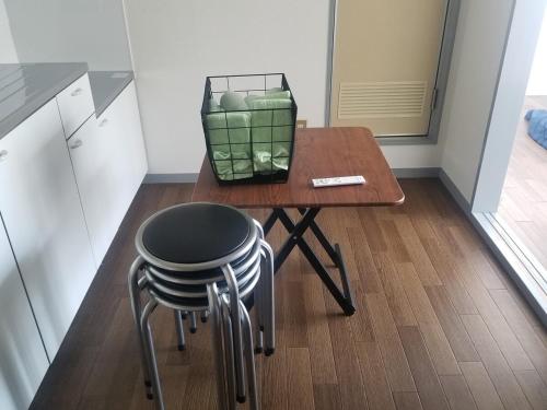 a small table with two stools and a small table with a stool at Sun and Moonホテル302 in Tokyo