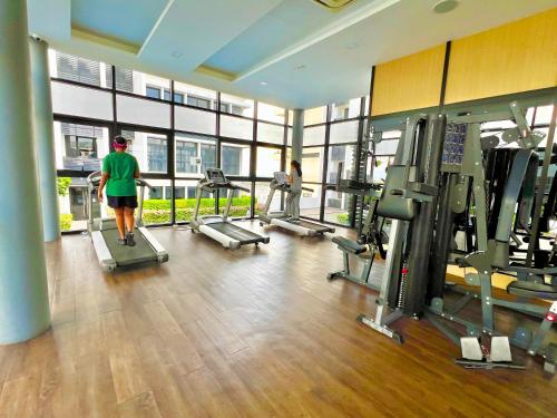 a man walking in a gym with treadmills at EcoNest 3Bedroom Family Apartment 8px Near Legoland in Iskandar Puteri