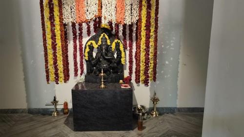 a room with a altar with flags on the wall at Shri Ganesh Residency And Restaurant in Dharmastala