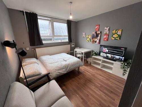 a small room with a bed and a couch at The Friary House - Central Guildford Personal 1 Bedroom Budget Apartment in Guildford