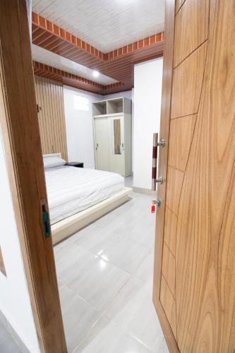 a door leading into a room with a bed at Sakaloka Mountain Homestay in Besakih
