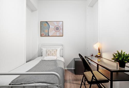 a white bedroom with a bed and a desk at Traditional Single Room - Ideally Located at Kensington - Shared Bathroom in Sydney