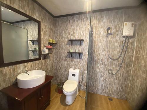 a bathroom with a shower and a toilet and a sink at Luangprabang Town Pavilion Hotel in Luang Prabang