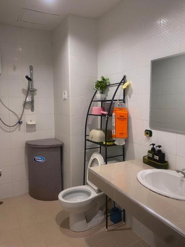 a bathroom with a toilet and a sink at Patong Rest & Recharge in Patong Beach