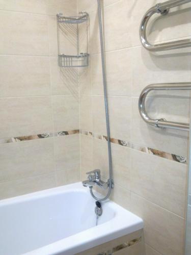 a bathroom with a bath tub and a sink at LD apartamenti in Ventspils