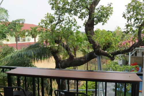 a view of a tree from a balcony at Baan Bee Residence in Nong Prue