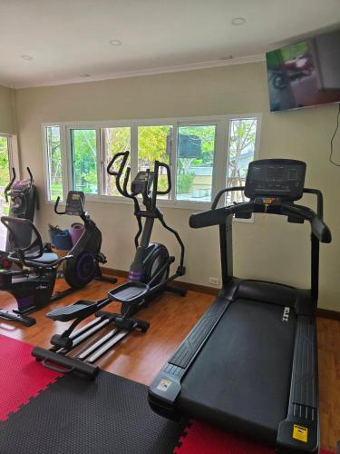 a gym with several exercise bikes in a room at Baan Bee Residence in Nong Prue