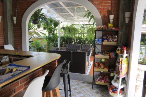 a room with a table and chairs in a restaurant at Baan Bee Residence in Nong Prue