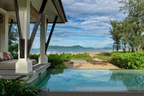 a house with a swimming pool next to a beach at Banyan Tree Lang Co in Lang Co