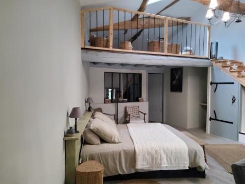a bedroom with a bed and a loft at Chambres d'hotes "Chez Marchio" in Crottet