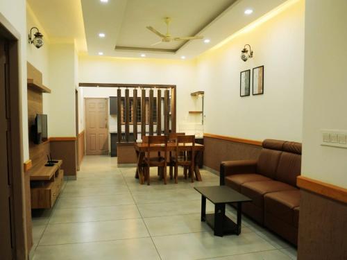 a living room with a couch and a table at Aqualuxe Premium Suites in Vythiri