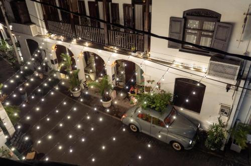 a car parked in front of a building with lights at Prince of Galle (inside the Fort) in Galle