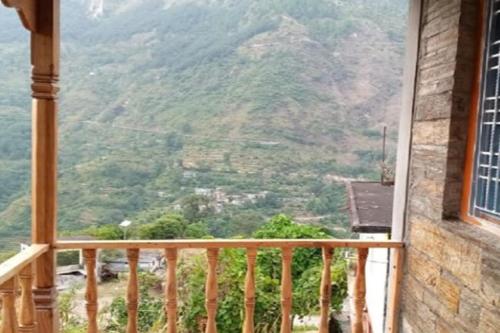 a balcony with a view of a mountain at Himalayan Hills Village Retreat by StayApart, Ukhimath in Rudraprayāg
