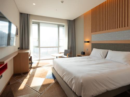 a hotel room with a bed and a television at Urbanstay Residence Dongtan in Hwaseong