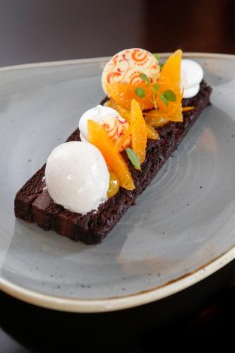 a piece of cake with ice cream and fruit on it at Four Seasons Hotel Denver in Denver