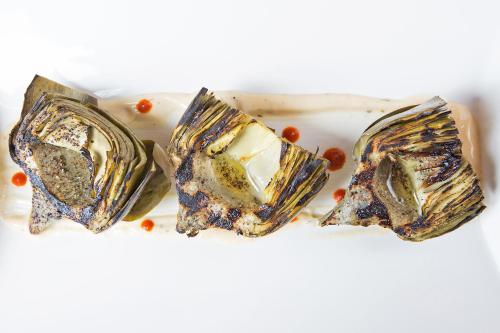 three pieces of oysters on a white plate at Four Seasons Hotel Denver in Denver