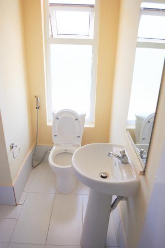 a bathroom with a toilet and a sink at Supastop Rest & Go in Sultan Hamud