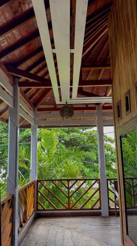 a room with a ceiling with a view of a forest at Rock Pool Homestay in Huu
