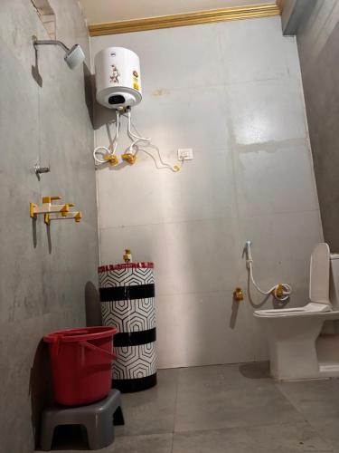 a bathroom with a toilet and a camera on the wall at Hotel Radha Madhavam Luxurious Boutique Stay in Mathura