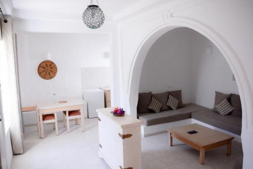 a living room with a couch and a table at Les Jardins de Toumana in Triffa