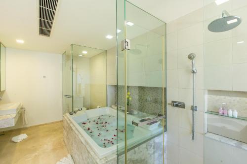 a bathroom with a tub and a glass shower at The heights Penthouse Ocean view A11 Near Kata Beach in Kata Beach