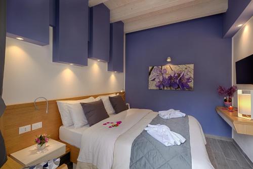 a bedroom with two beds and purple walls at Hospitality Hotel in Palermo