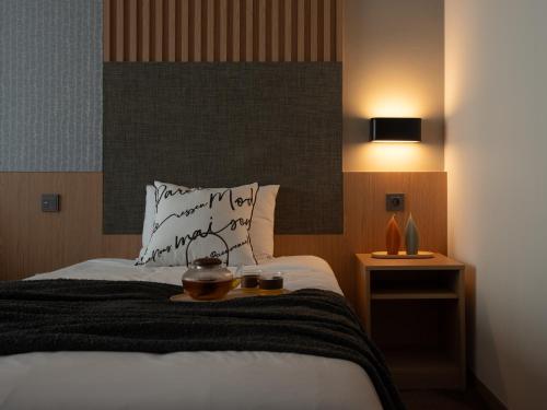 a bedroom with a bed with two candles on it at Urbanstay Residence Dongtan in Hwaseong