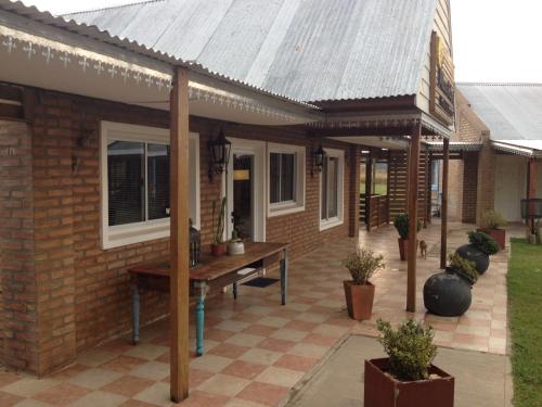 a brick house with a table on a patio at Altos de Adonai in Pueblo Quintana