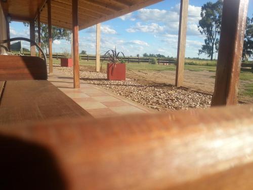 a pavilion with a picnic table and a field at Altos de Adonai in Pueblo Quintana