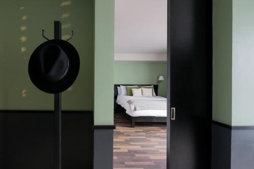 a bedroom with a bed and a tv in the corner at Lusitania Suites in Orizaba