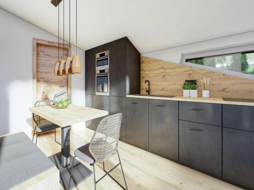 a kitchen with gray cabinets and a wooden table and chairs at Bergzeit flat Saalbach directly on the ski piste in Saalbach Hinterglemm
