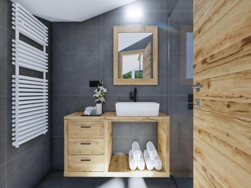 a bathroom with a sink and a mirror at Bergzeit flat Saalbach directly on the ski piste in Saalbach Hinterglemm
