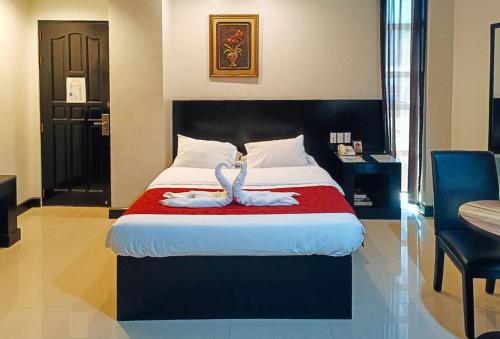 Postel nebo postele na pokoji v ubytování Check Inn Hotel Dumaguete City by RedDoorz