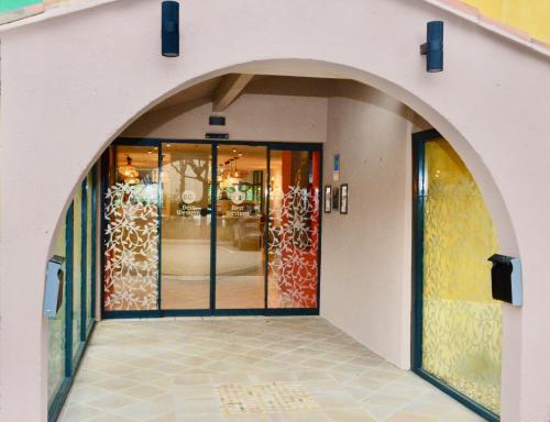 une entrée à un magasin avec portes en verre dans l'établissement Best Western Gemenos Villa Florette, à Gémenos