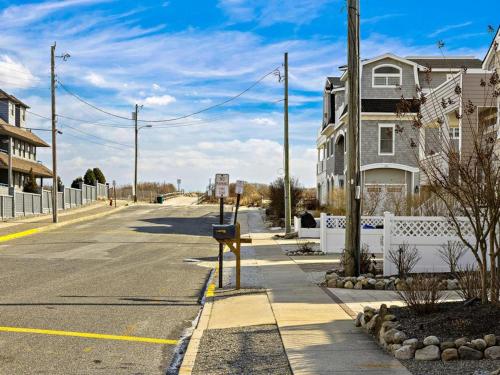 an empty street with a house on the side of the road at Stunning Ocean Block W-A Pool, New Construction! in Ship Bottom