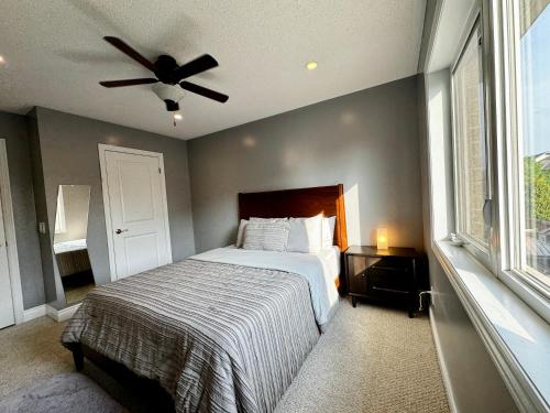 a bedroom with a bed and a ceiling fan at Connected Comfort - 7BR Family Retreat - Near Pearson Airport & Toronto Downtown in Brampton