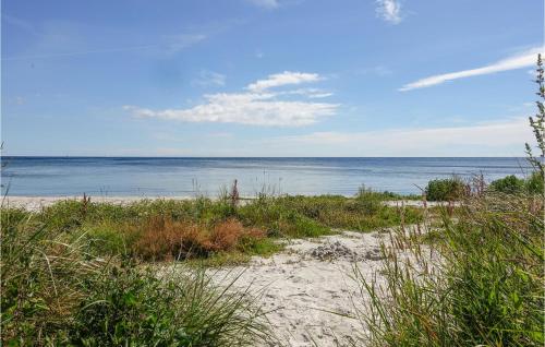 a sandy beach with the ocean in the background at Stunning Home In Nexø With Kitchen in Neksø