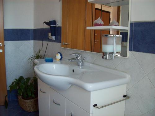 a bathroom with a white sink and a mirror at Casa Mia in Florence