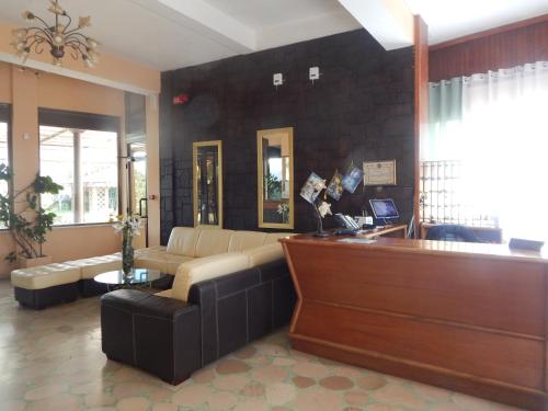 a living room with a couch and a table at Hotel Calypso in Ardea