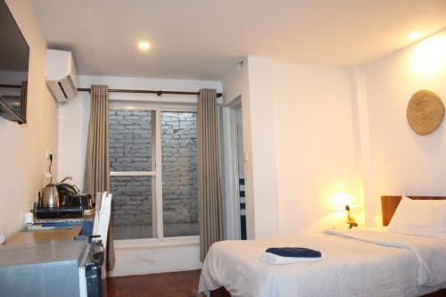 a hotel room with a bed and a window at KAJI HOME in Pātan